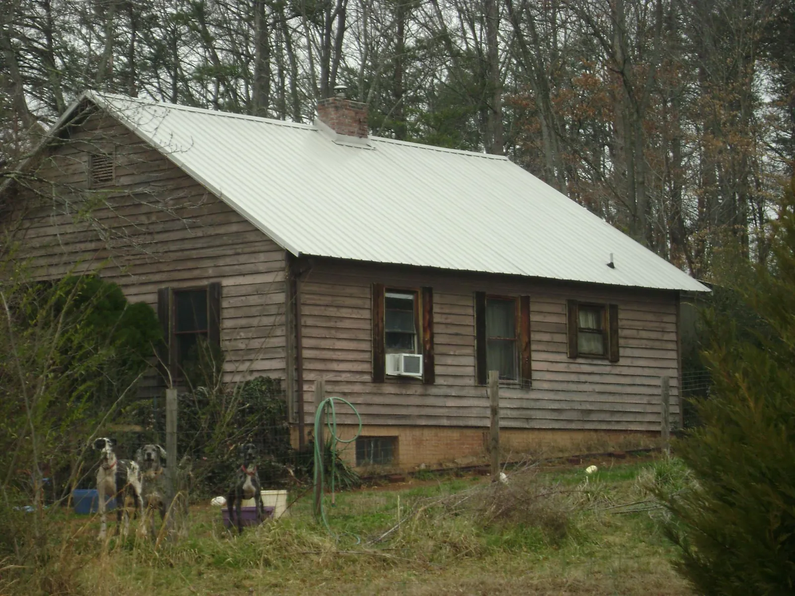 White metal roof on an old wood sided farmhouse, from a Metal Roof Installation job in Taylorstown